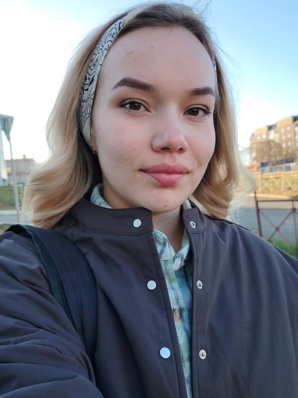 Woman takes selfie as dog walks in Russian town