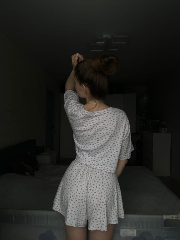 Woman photographed in bedroom setting in Klin, Russia