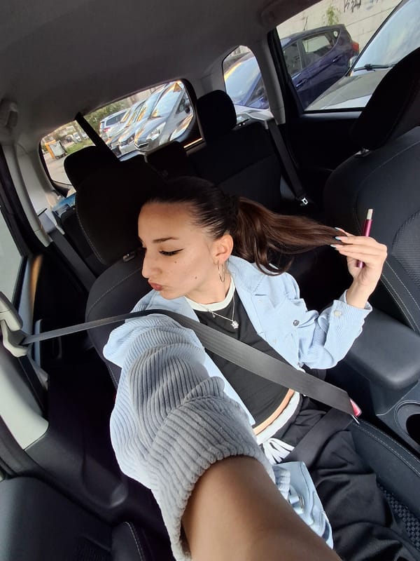 Woman rests in car passenger seat, Sofia