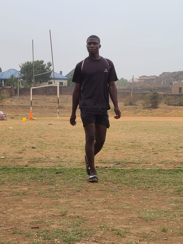Morning gathering on soccer field in Nigerian village