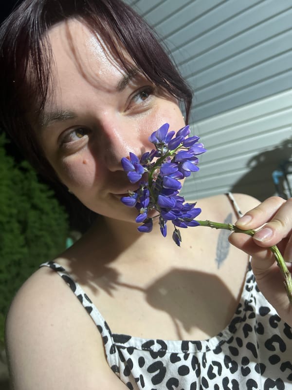 Woman photographs flower-themed evening portrait session in Russian village
