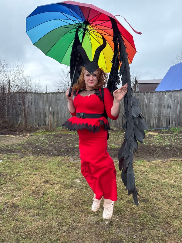 Costumed woman poses with rainbow umbrella in Chaikovsky, Russia