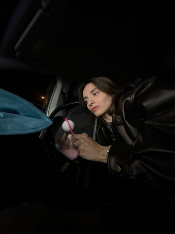 Parent tends to child with toy rattle in Moscow car