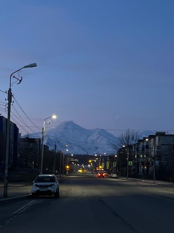 Dawn street scene captured in Petropavlovsk-Kamchatsky with mountain backdrop