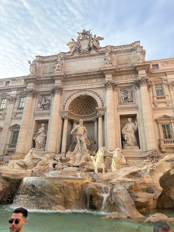 Tourists photograph Rome's iconic Trevi Fountain on Sunday afternoon