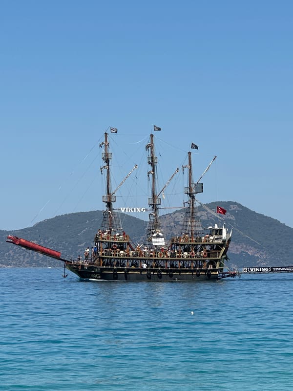 Pirate boat and jet ski share Fethiye's morning waters