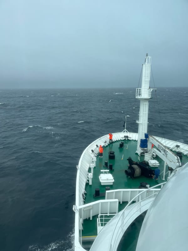 Ship navigates rough waters with crew on bridge