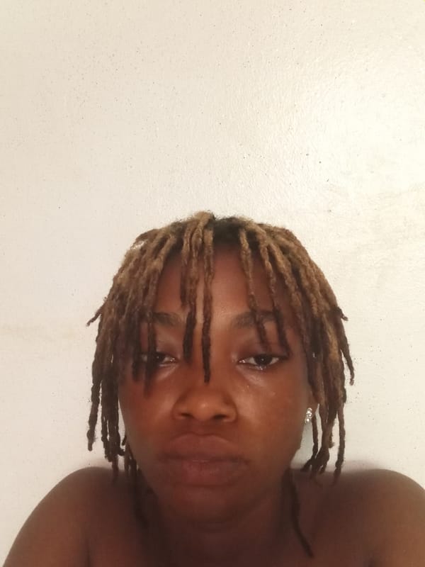 Person with dreadlocks poses for peace sign portrait photos