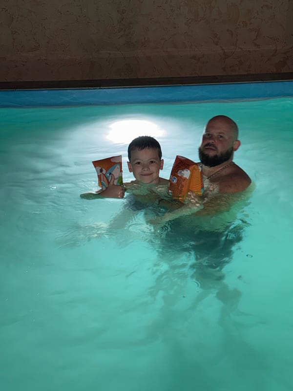 Father and child enjoy evening swim in Krasnaya Polyana
