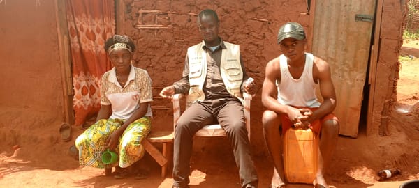 Residents gather outside traditional homes in rural DR Congo
