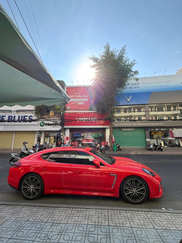 Red Porsche, monks, and street vendors on a Nha Trang corner