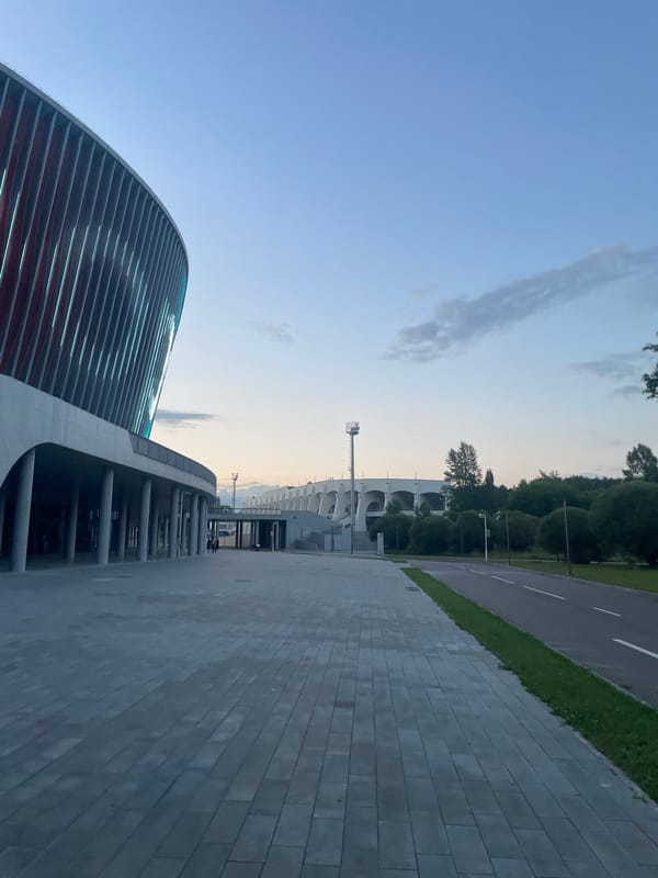 Modern stadium exterior lit up in rotating colors