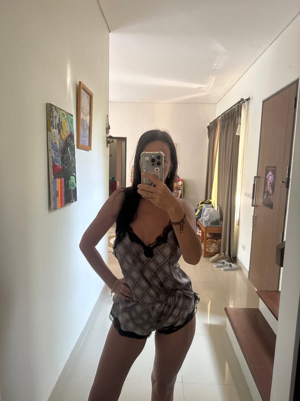Woman takes bathroom selfie in plaid pajamas
