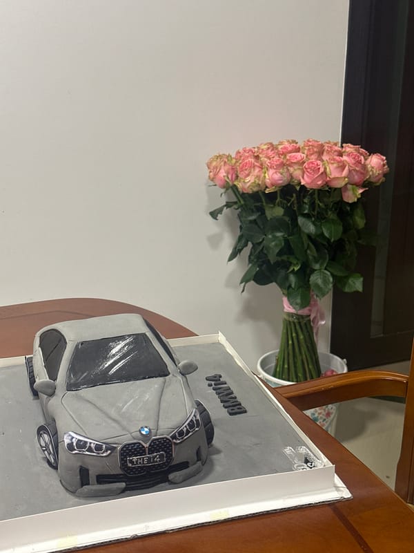 BMW car cake with pink roses photographed in Yerevan