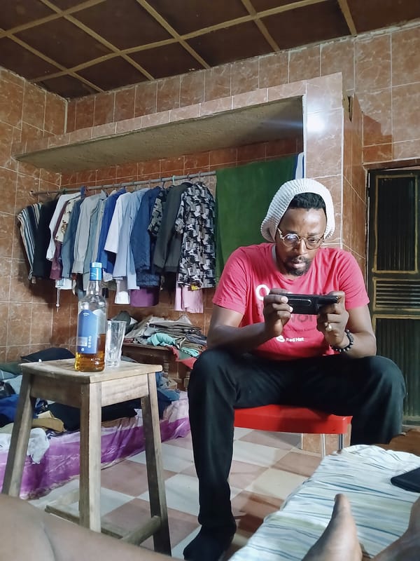 Men using phones in casual settings observed in Kitwe