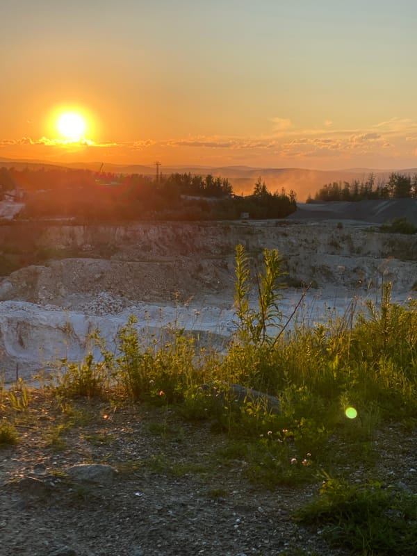 Sunset over a Yekaterinburg quarry, rock and wildflowers