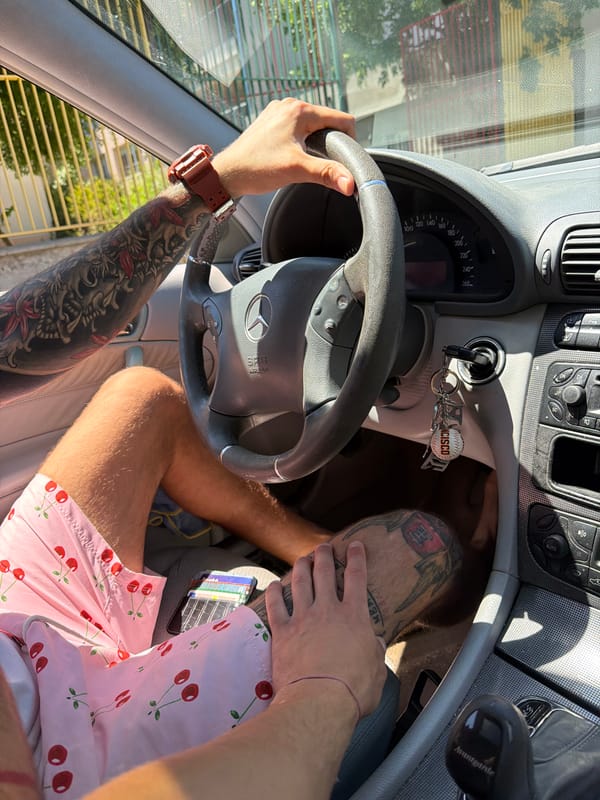 Tattooed Person Rests in Car, on Pillow in Tsarevo