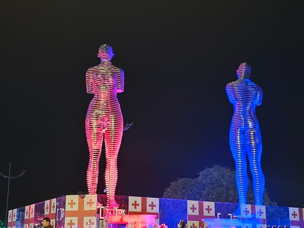Batumi waterfront at night: iconic sculpture and Ferris wheel
