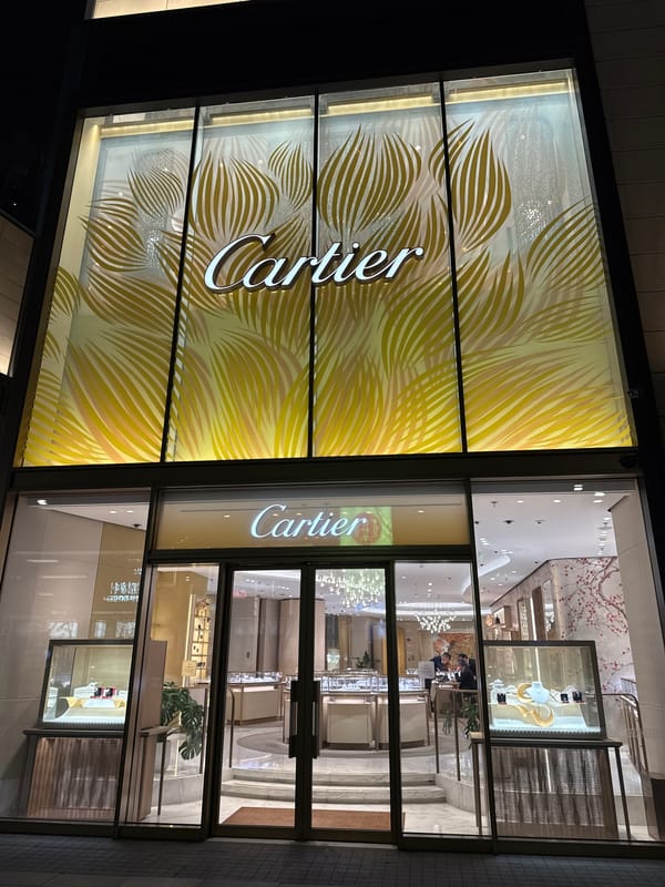 Luxury retail district bustling with shoppers and F1 display
