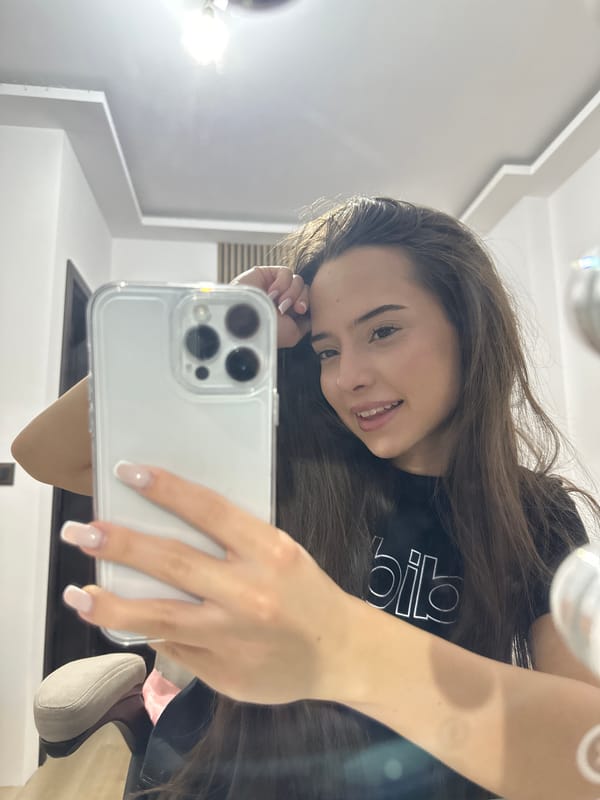 Woman Takes Multiple Mirror Selfies in Black Adidas Shirt