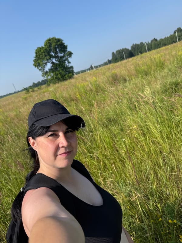 Sunny afternoon in a grassy Izhevsk field with an oak tree