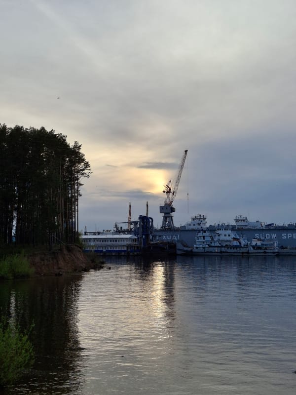 Afternoon waterfront stroll documented in Chaikovsky, Russia industrial port area