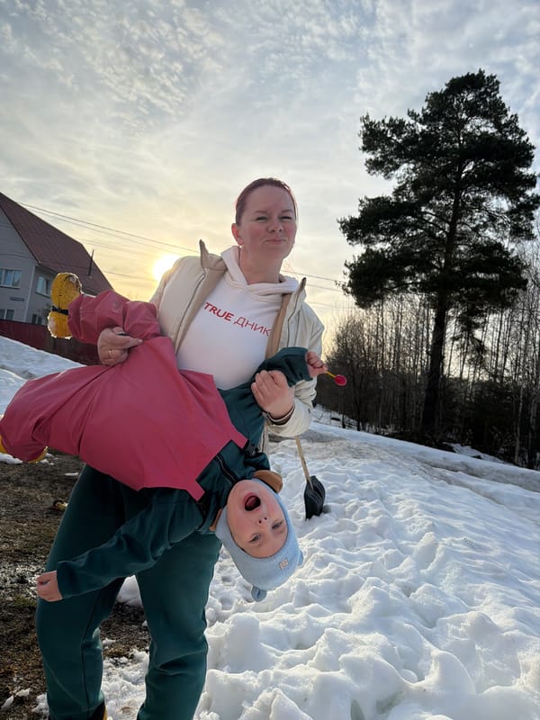 Family day outdoors in snowy Chaikovsky with dog