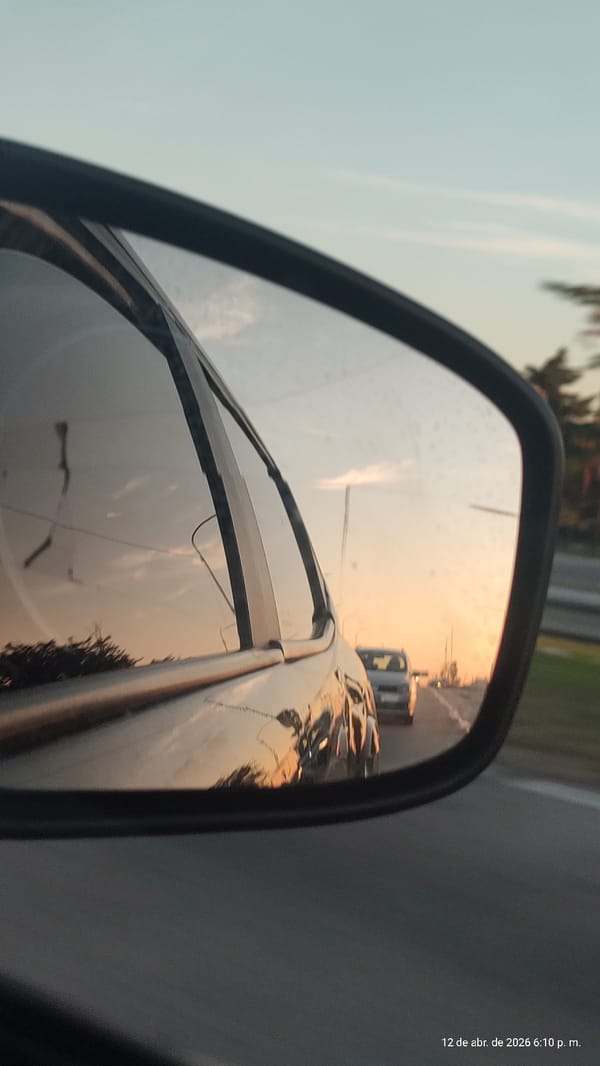 Driver captures sunset reflection in side mirror, Villa Domínico