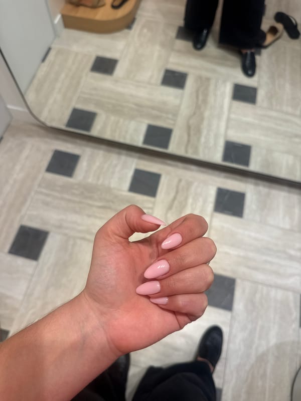 Manicured hand photographed against mirror in Paris