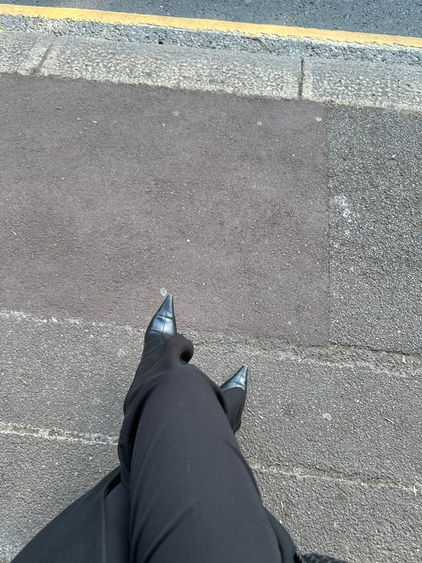 Person in black attire observed standing on London street