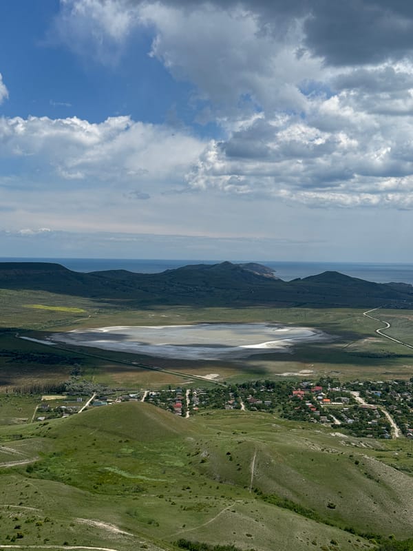 Aerial view captures Koktebel Ukraine mountains meeting cloudy sky