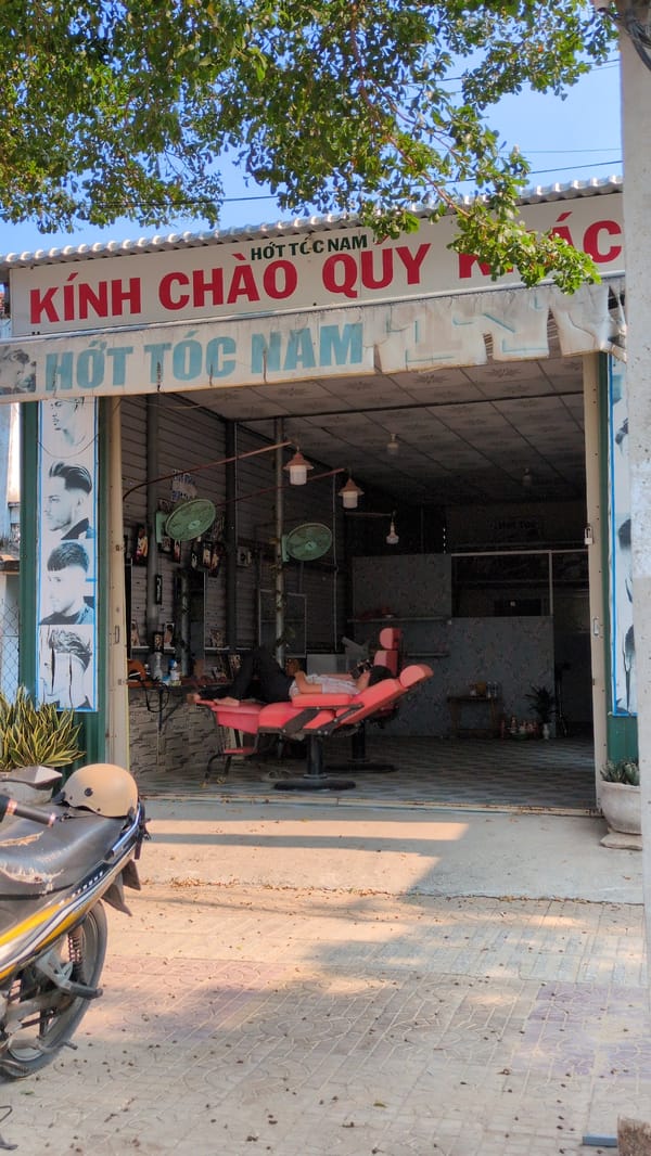 Barber shop serves customer in Phan Rang street scene