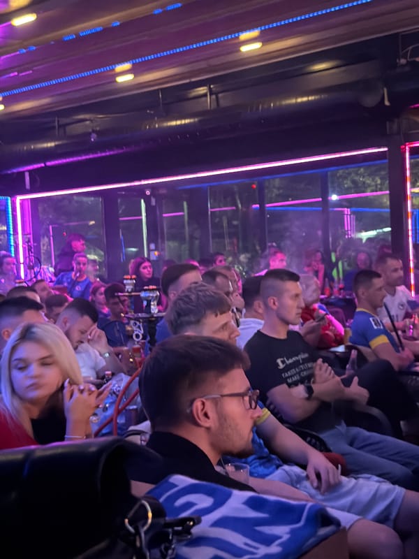 Watching football at a neon-lit bar in Travnik