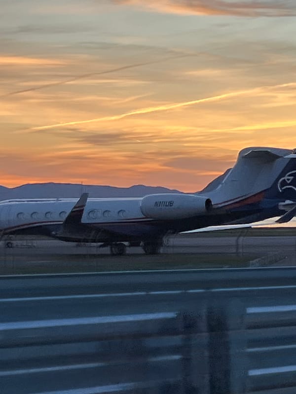 Private jet on tarmac during colorful sunset in Montenegro