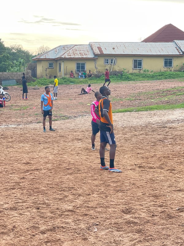 Pickup football on a dirt pitch in Lokoja, Nigeria