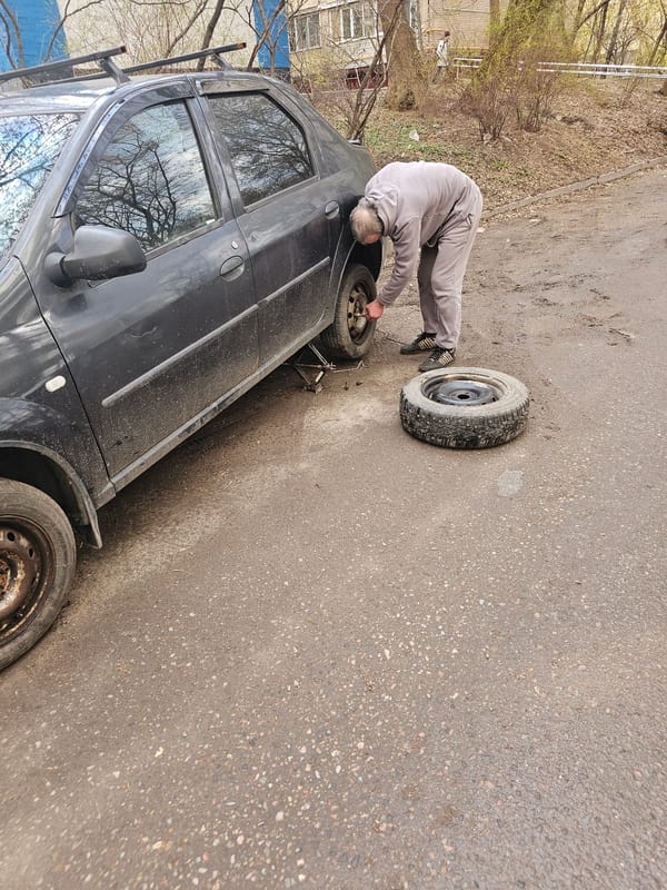 Man changes tire on Moscow street