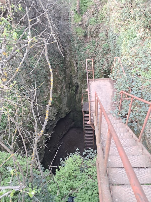 Metal staircase descends into natural chasm in Bulgaria