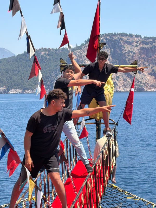 Young tourists pose playfully on pirate boat tour in Alanya