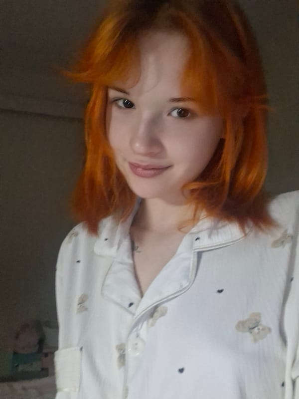 Orange-haired woman documented in indoor portraits, Chaikovsky Russia