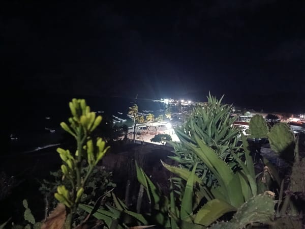 Tourist documents nighttime views of Juan Griego coastal bay