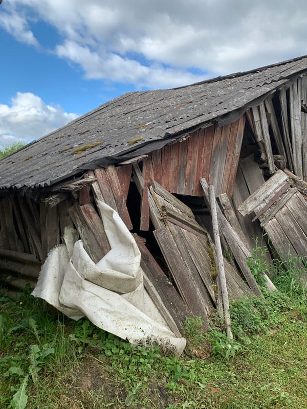 Rural Belarus village life documented through weathered structures, gardens