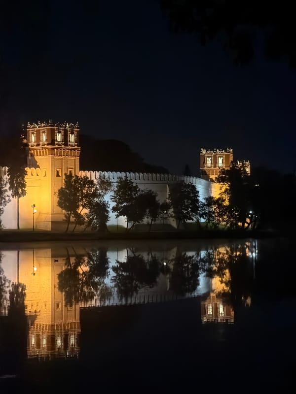 Illuminated Moscow fortress captured in nighttime reflection photograph