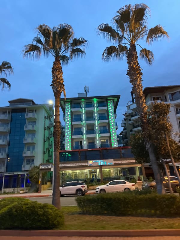 Hotel displays green decorative lights in Alanya nighttime scene