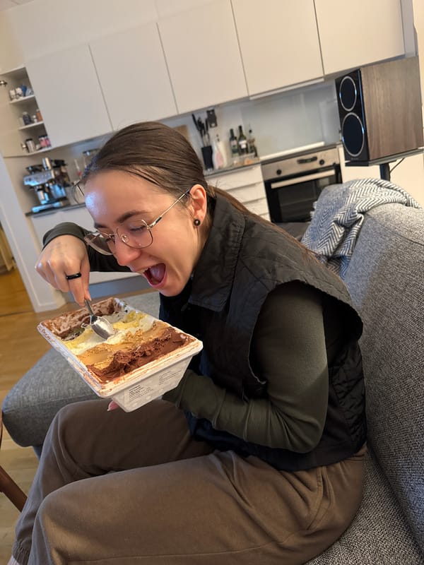 Woman enjoys ice cream on sofa in Copenhagen