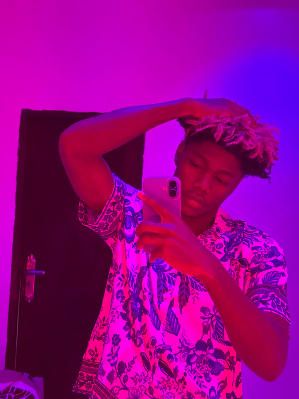 Self-portrait captured in colorfully lit room in Igboefon