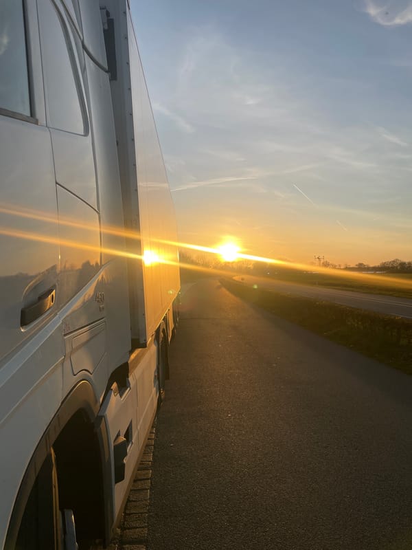 Truck parked roadside in sunlit Volkel, Netherlands evening