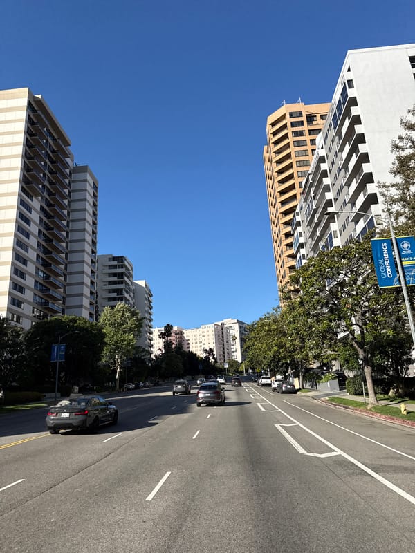 Clear night captures modern high-rises lining Los Angeles street