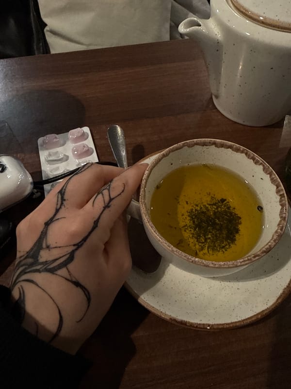 Moscow cafe patron enjoys herbal tea with medication nearby