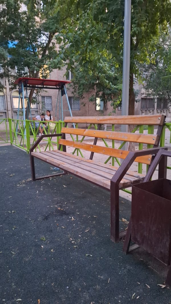 Shymkent residential playground and courtyard, summer afternoon