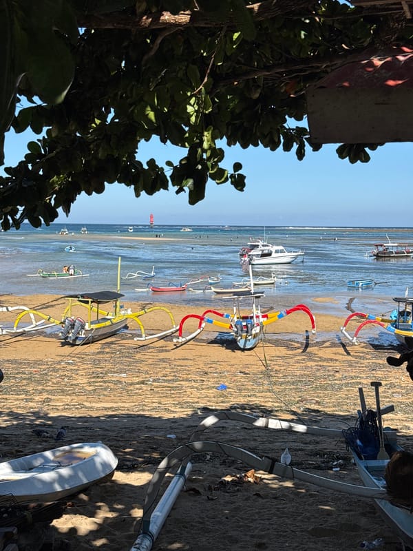 Morning coastal scenes documented in Denpasar featuring traditional boats